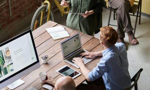 Casual workspace with diverse team working and interacting in a modern office.